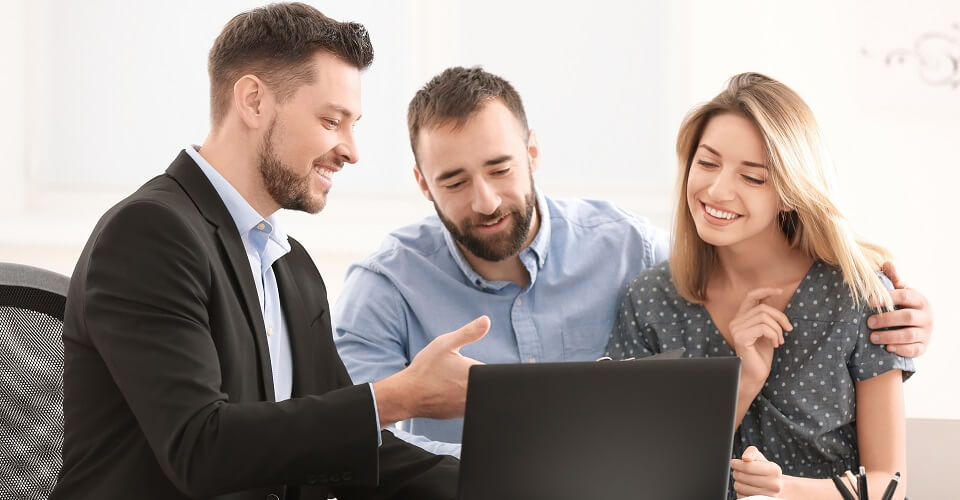 Businessman consulting young couple in office